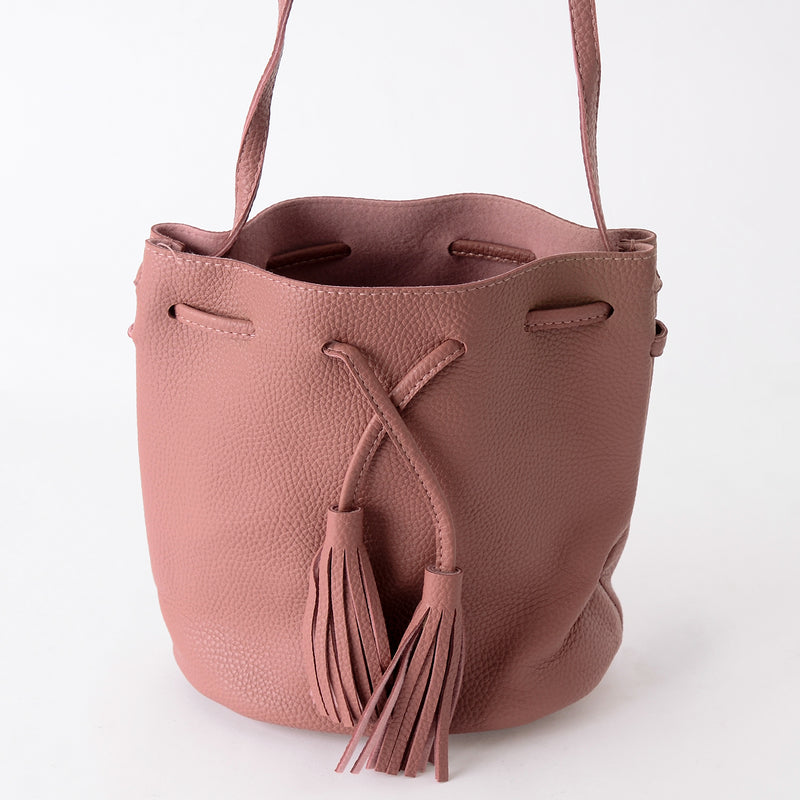 Faux leather shoulder bag with drawstring closure 