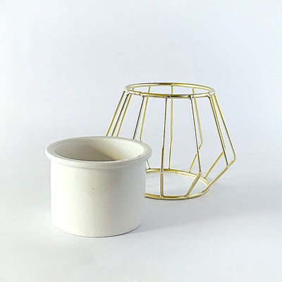 Decorative ceramic vase with a gold metal stand in a geometric shape