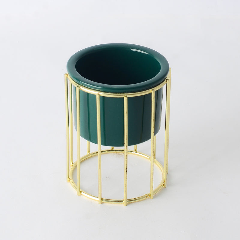 Decorative ceramic vase with a gold metal stand in a geometric shape