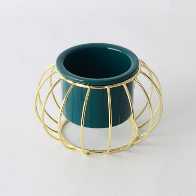 Decorative ceramic vase with a gold metal stand in a geometric shape