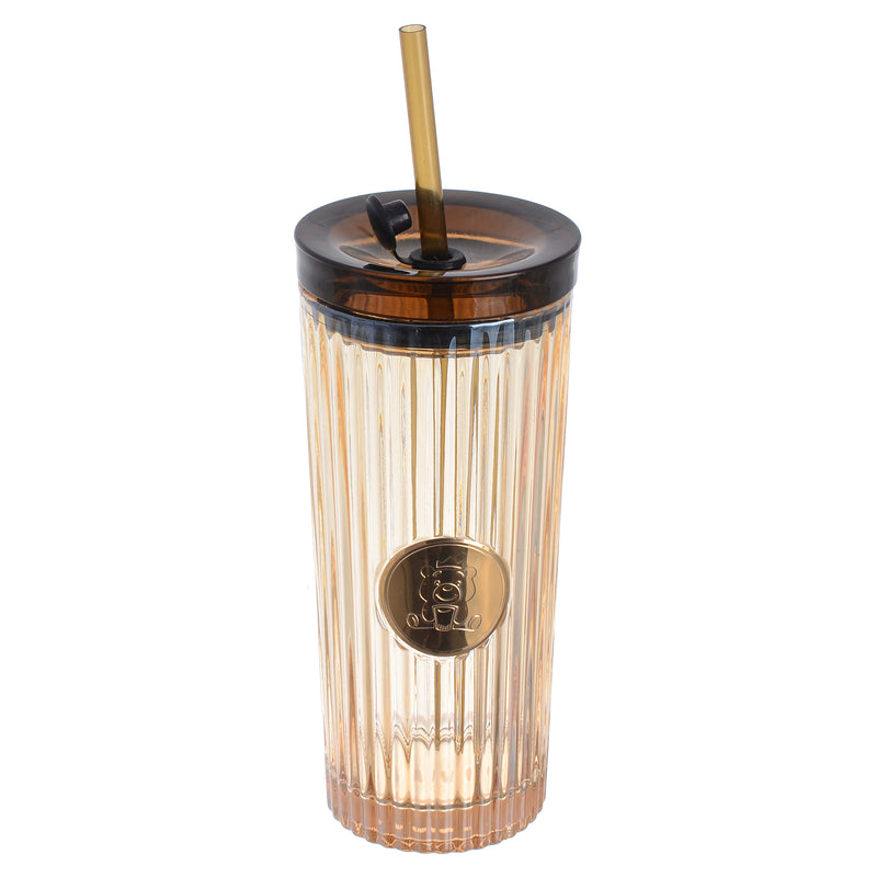 A graduated glass cup with a straw in the shape of a gummy bear with a tight-fitting lid