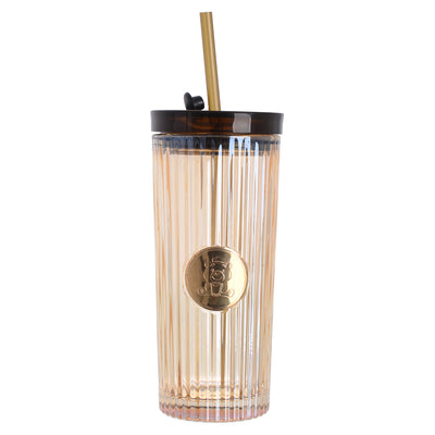 A graduated glass cup with a straw in the shape of a gummy bear with a tight-fitting lid