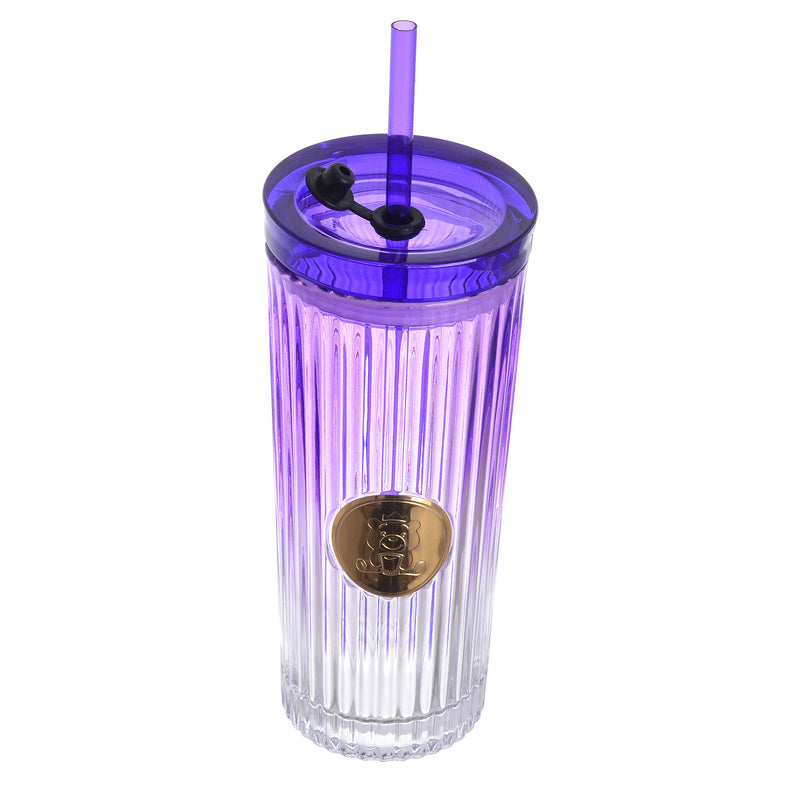 A graduated glass cup with a straw in the shape of a gummy bear with a tight-fitting lid