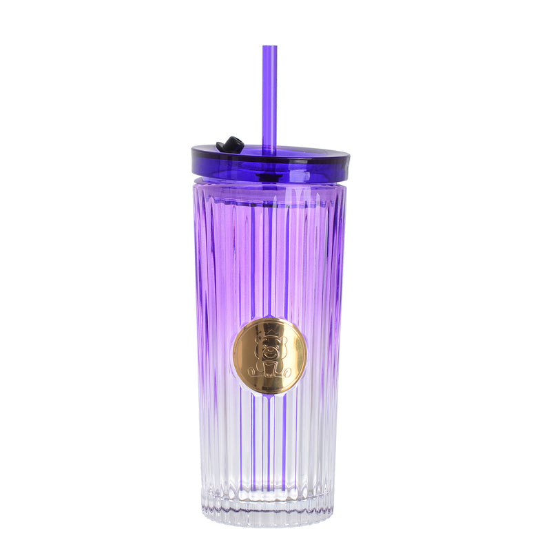 A graduated glass cup with a straw in the shape of a gummy bear with a tight-fitting lid