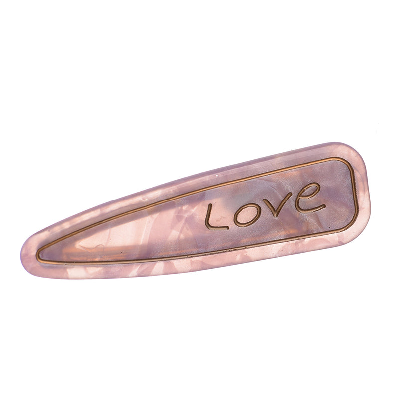 Hair clip with the word “Love” design