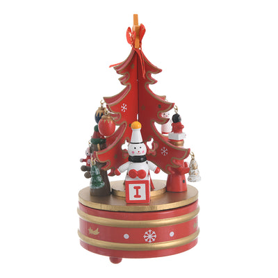 A Christmas music box with a wooden revolving design and a red, gold, and white spring