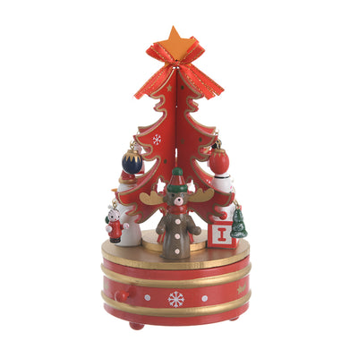 A Christmas music box with a wooden revolving design and a red, gold, and white spring