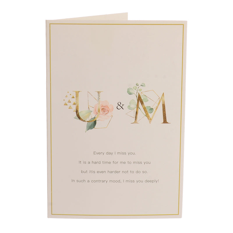 A rectangular greeting card with U &amp; M written in white