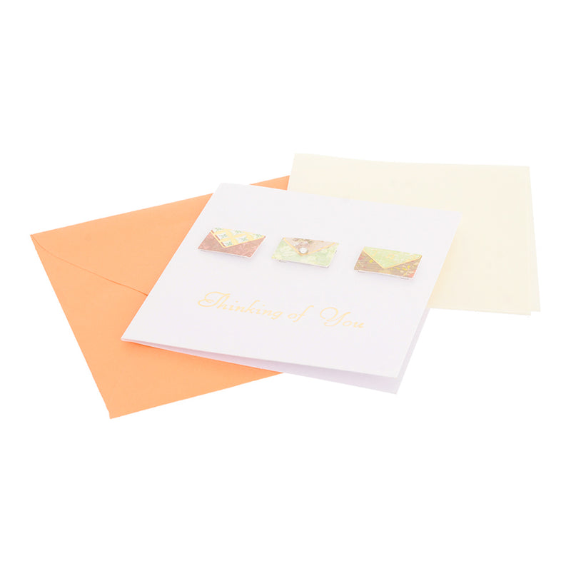 A square greeting card with an orange envelope