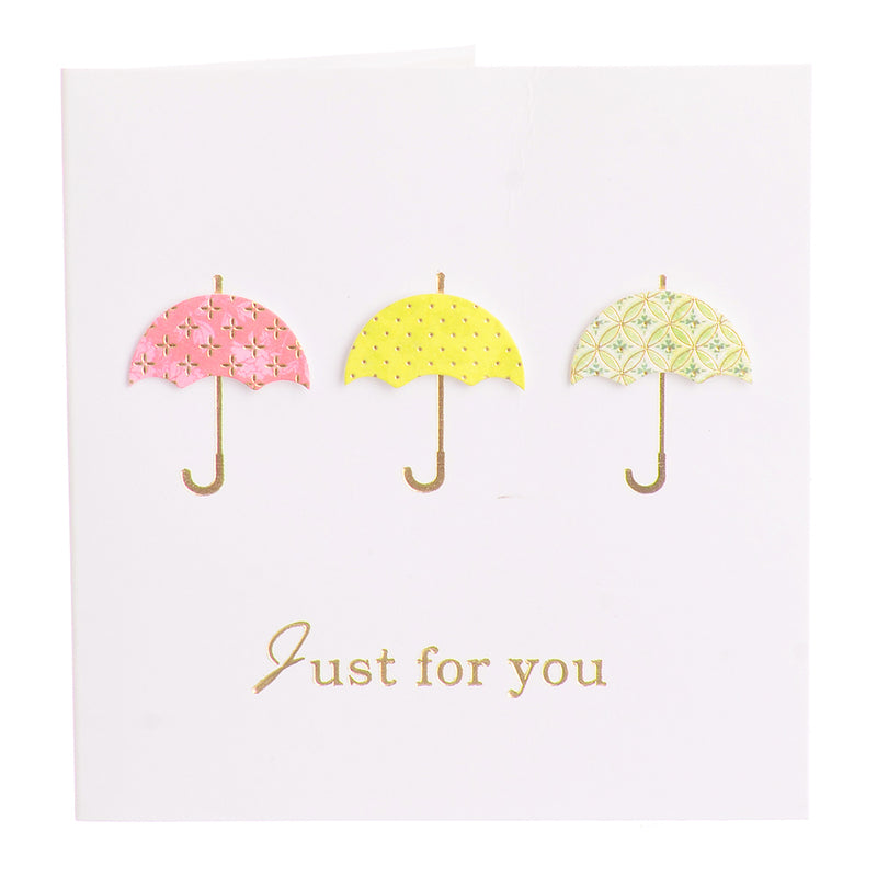 A square greeting card with a pink umbrella-shaped envelope