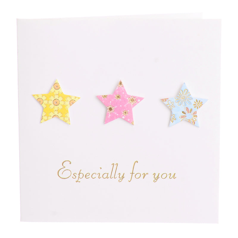 A square greeting card with a green star-shaped envelope