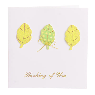 A square greeting card with an orange leaf-shaped envelope