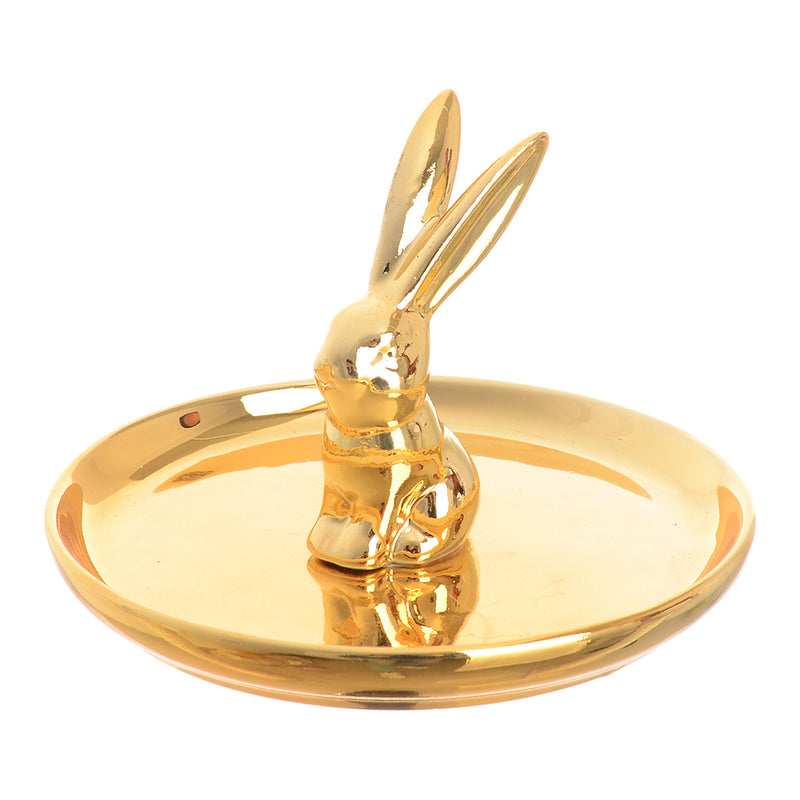 A circular ceramic dish with a rabbit-shaped ornament organizer, with a golden middle