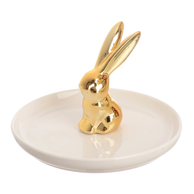 A circular ceramic dish with a rabbit-shaped ornament organizer in the middle, white and gold