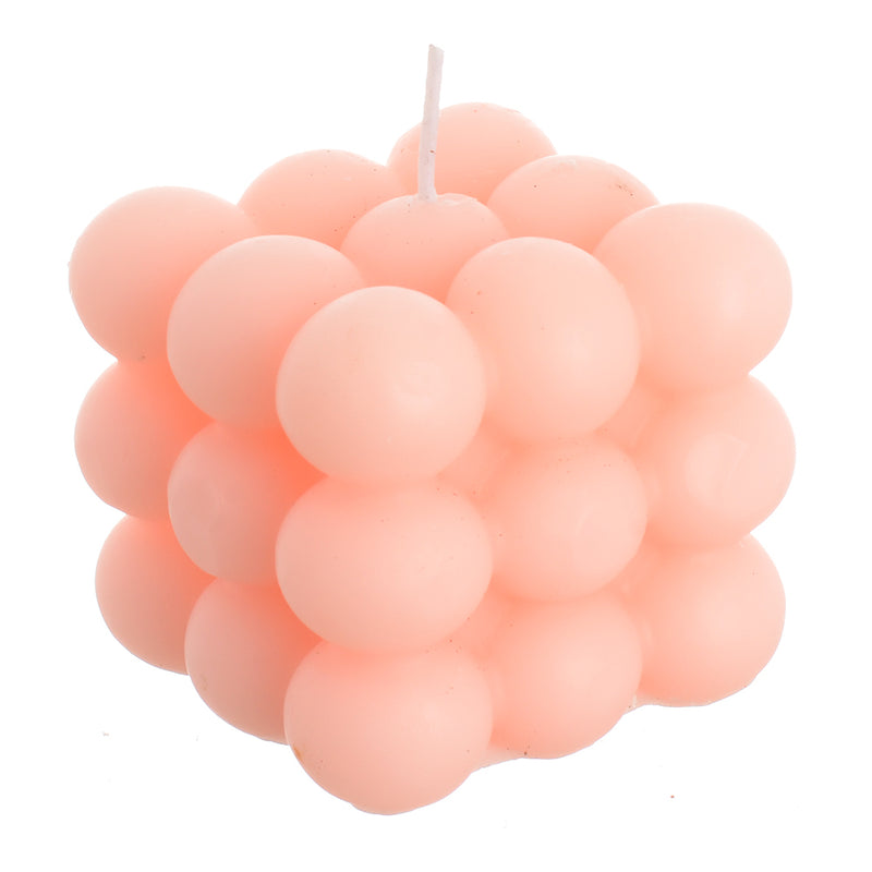 Scented wax cube, pink wax bubbles attached to the wrapper