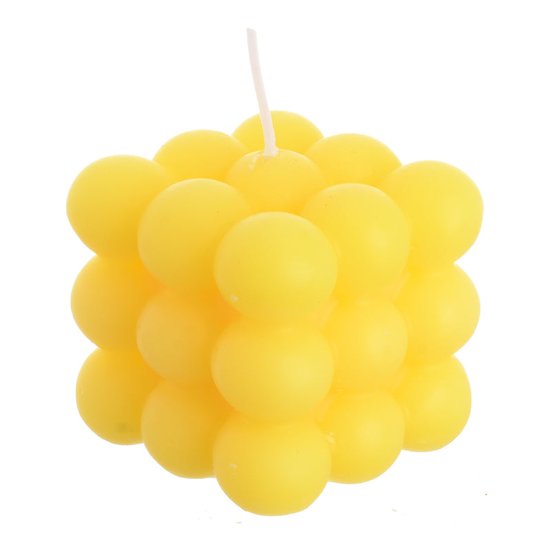 Scented wax cube with wax bubbles attached to the yellow wrapper