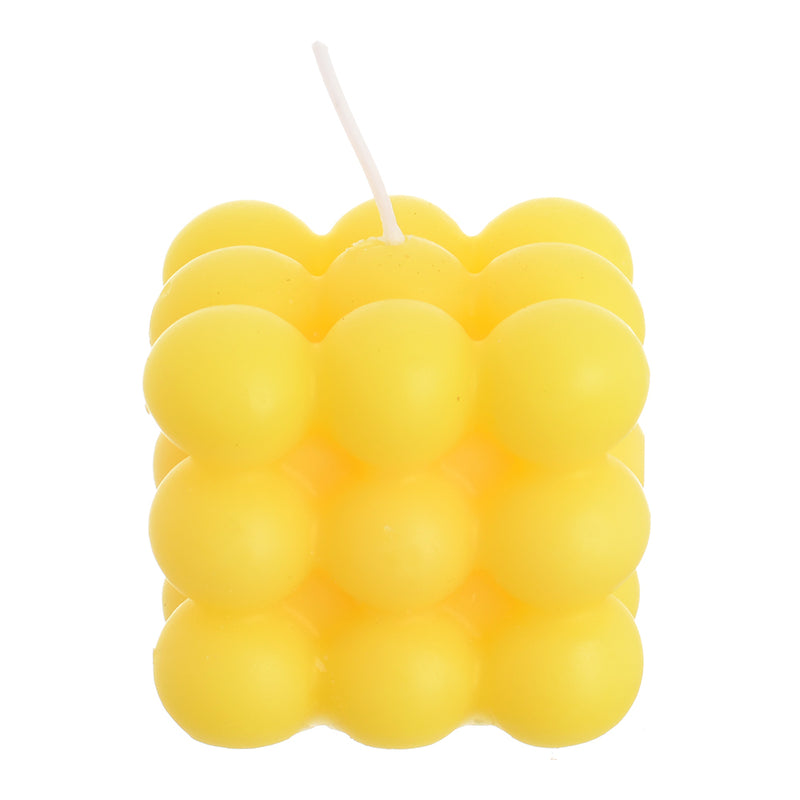 Scented wax cube with wax bubbles attached to the yellow wrapper