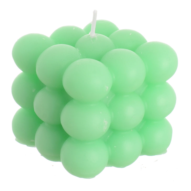 Scented candle cube with wax bubbles attached to the turquoise wrapper