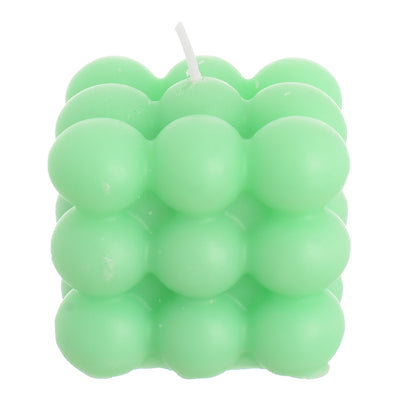 Scented candle cube with wax bubbles attached to the turquoise wrapper